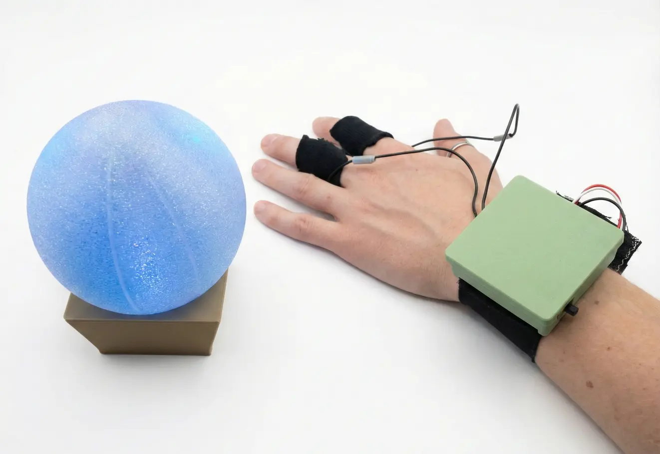 SENSA stress-response prototype with an illuminated sphere and wearable sensors